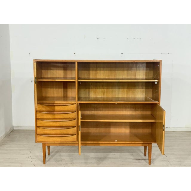 For sale is a very beautiful vintage sideboard from Hellerau (Series 602) in good condition. This highboard offers...