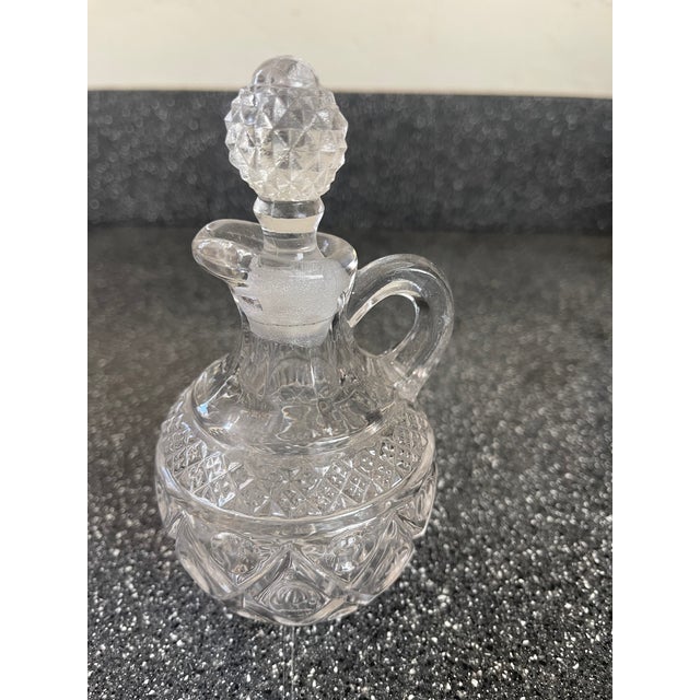 small decorative glass containers for oil or vinegar for the dining table. I do not know the style of the cruets.