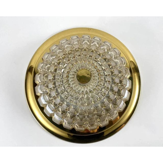 Round ceiling light in gilt metal and cut glass plafond. mid-century modern polished metal rim with a cut glass shade...