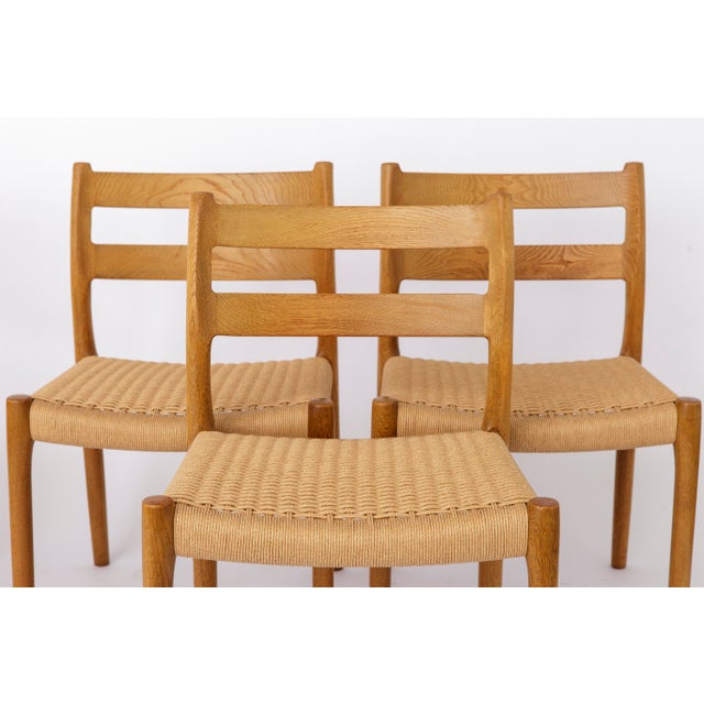Set of 4 Niels Otto Møller Dining Chairs, Model 84, Oak, 1970s Crafted from solid oak, the frames have been carefully...
