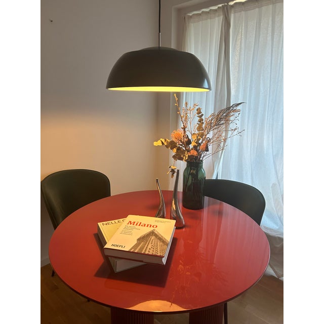 When illuminated, a subtle luminous ring glows at the lamp's midpoint — light escaping through the joint between dome and...