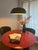 When illuminated, a subtle luminous ring glows at the lamp's midpoint — light escaping through the joint between dome and...