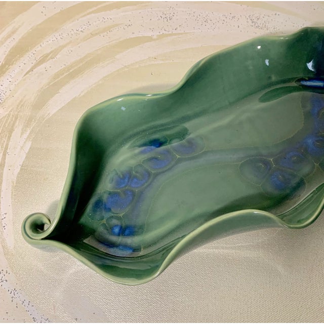 What a stunning large studio platter! Green base glaze with royal blue accenting and swirl handles! Use it in the bathroom...
