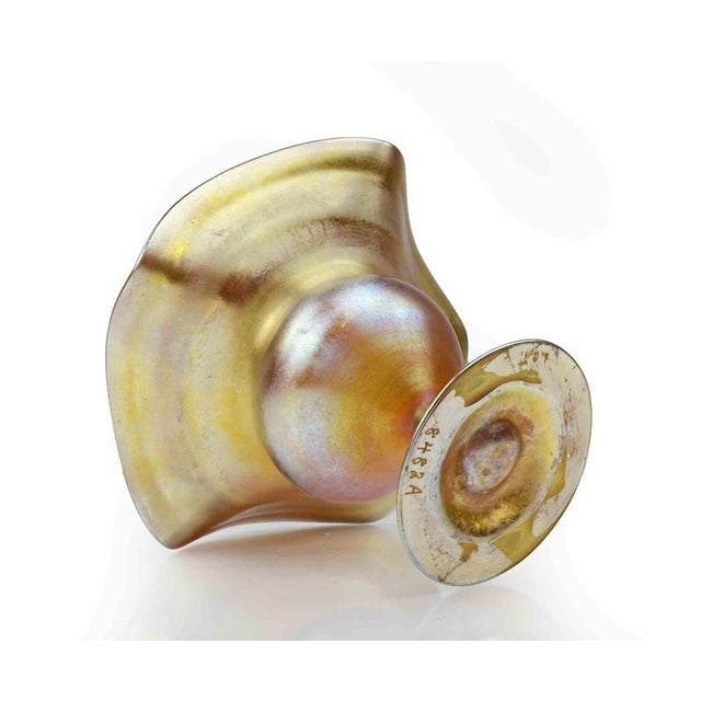 A gold iridescent Glass Compote by Tiffany Studios Favrile, realized around 1910. Market on base with acid 8482A. Very...