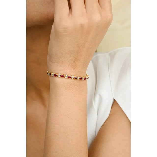 This is part of Chairish’s Fine Jewelry assortment. This 6.37 Carat Red Ruby Diamond Tennis Bracelet in 18K gold showcases...