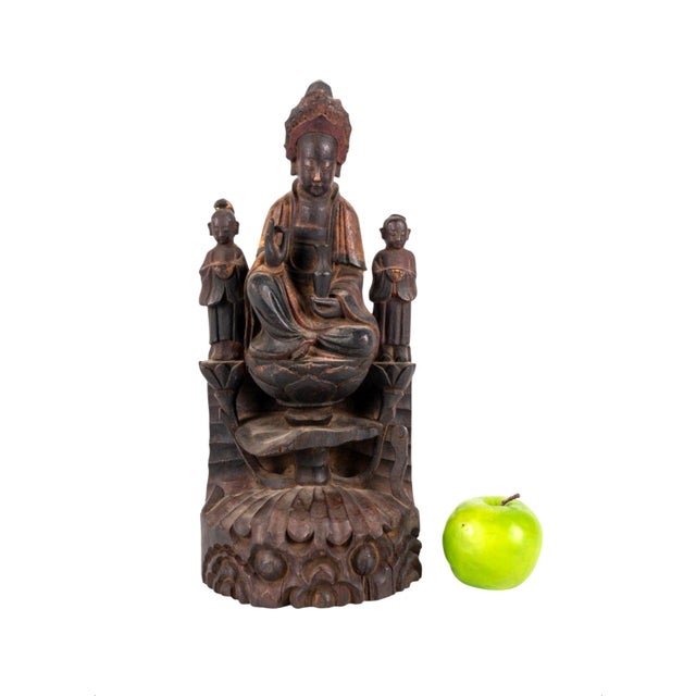 Striking 19th-century Chinese carved wood sculpture of Guanyin, the Buddhist bodhisattva traditionally associated with...