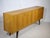 Vintage oak sideboard, 1960s. The sideboard features three lockable doors with spacious storage compartments and four...