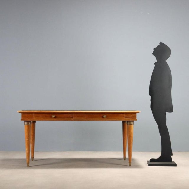 This 1950s Italian-made walnut table features a dark marble top that lends elegance and solidity. Two spacious drawers...