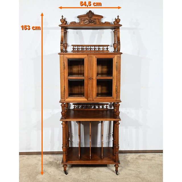 This rare music furniture has the particularity of having two glass doors barred or four bevelled windows. This double...