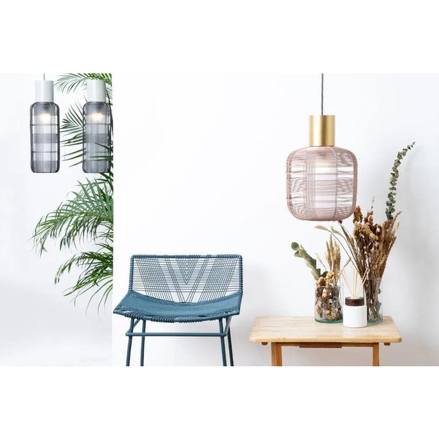Handcrafted in the Philippines from malleable galvanized iron wire, the Stout Pendant by Schema for Oggetti features a...