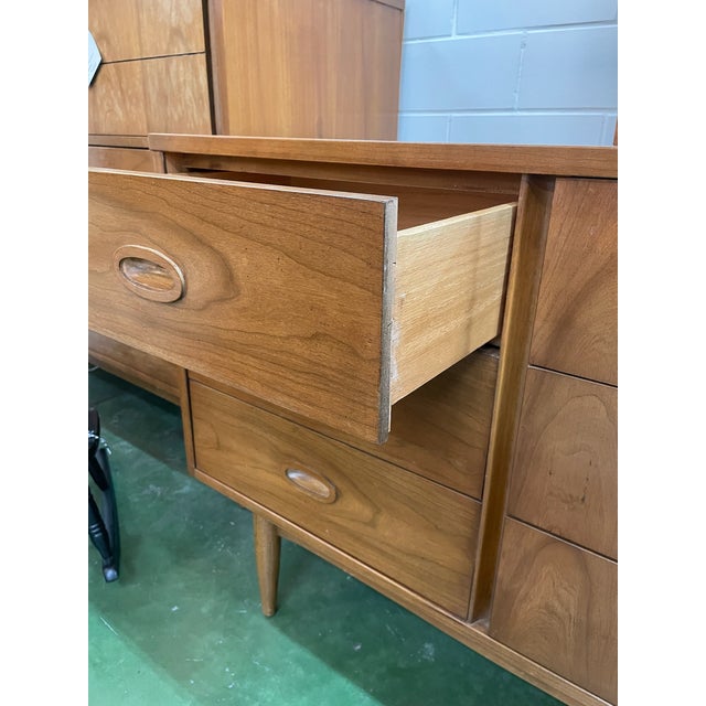 Gorgeous Mid Century cherry dresser by Dixie Furniture with 9 drawers, 6 of which have inset drawer pulls. Stands on a...