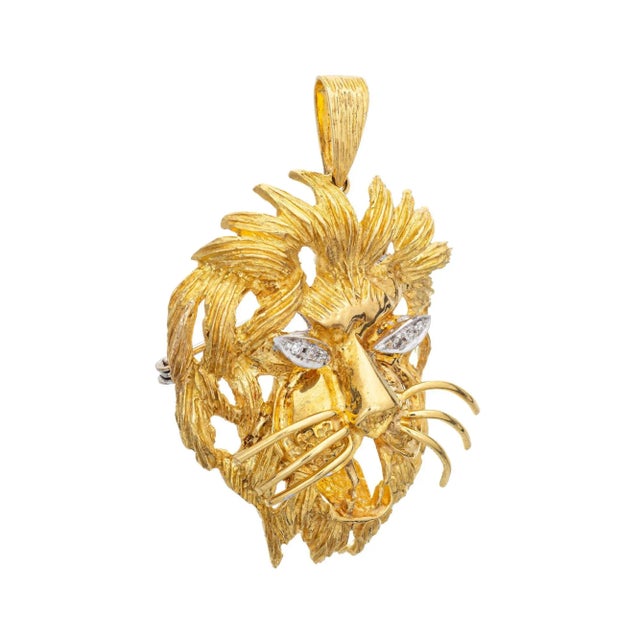 Finely detailed vintage Lion head pendant crafted in 18k yellow gold (circa 1970s to 1980s). Six single cut diamonds total...
