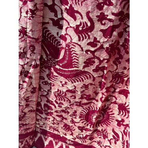Large printed batik, predominantly fuchsia, Indonesian ceremonial fabric. Peacock, flower and plant motifs. Length:...