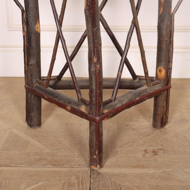 1920's Swedish folk made hazelnut and willow demi-lune console table. This piece is designed in the style of the selected...