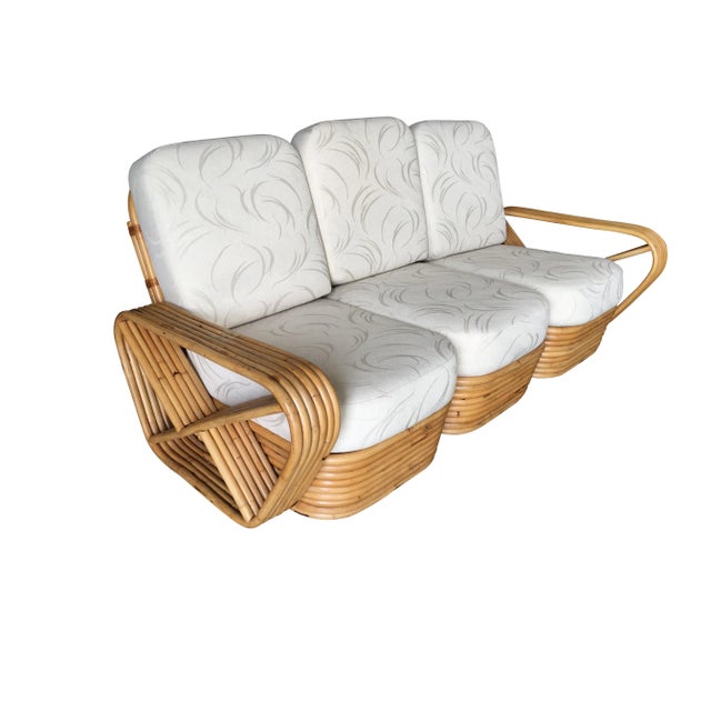 Paul Frankl style rattan living room set including a matching three-seat sectional sofa, and a pair of stacked matching...