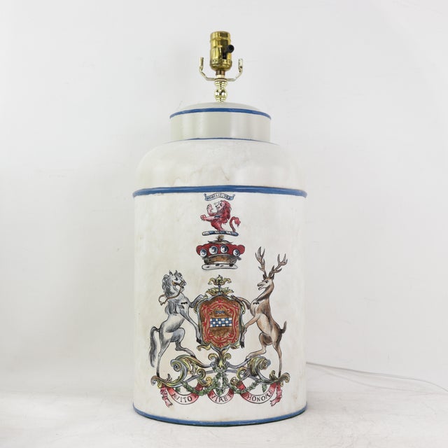 This sophisticated pair of vintage hand-painted tole table lamps features a classic cylindrical tea caddy silhouette in a...