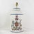 This sophisticated pair of vintage hand-painted tole table lamps features a classic cylindrical tea caddy silhouette in a...