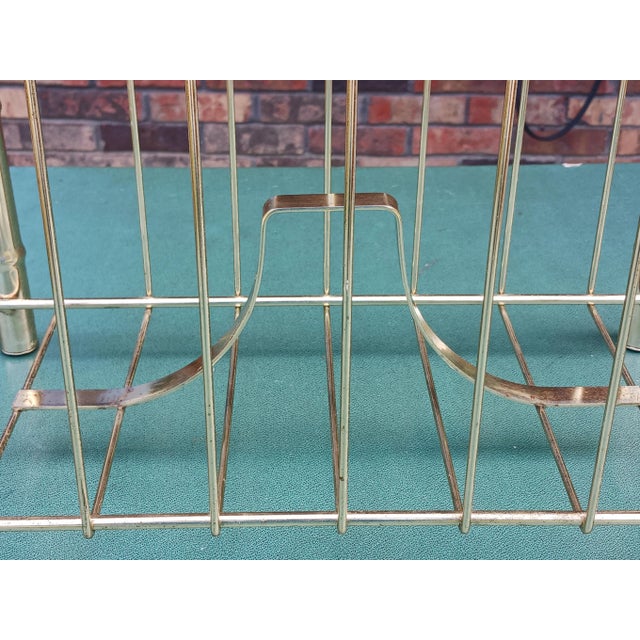 Solidly made brass magazine rack from midcentury. Added details are chrome rings and bamboo shaped design. 17" L x 16" H x...