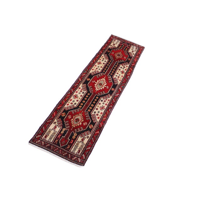 This beautiful handmade red runner rug features a bold tribal geometric design with a rich red field accented by cream,...
