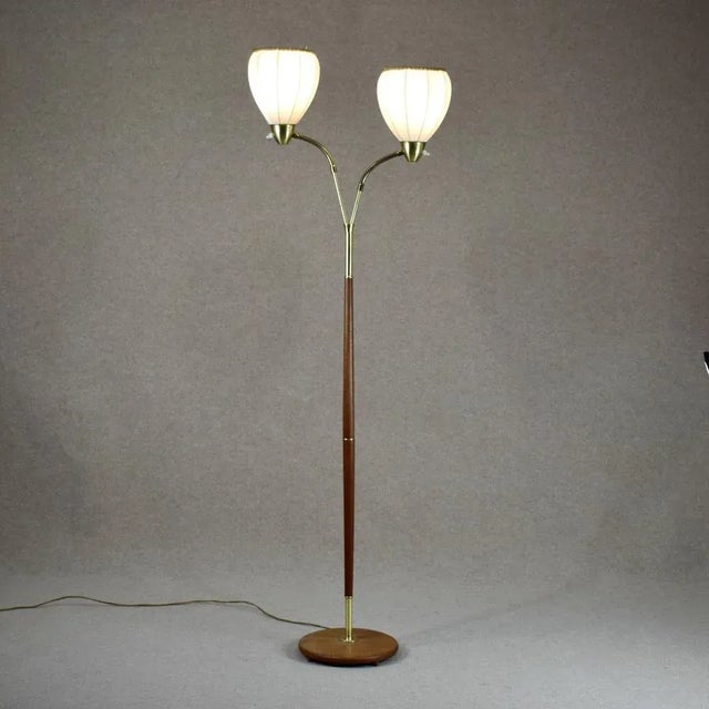 Very rare floor lamp from Möllers Armatur Eskilstuna. Made in brass, teak and original fabric shades. This piece has an...
