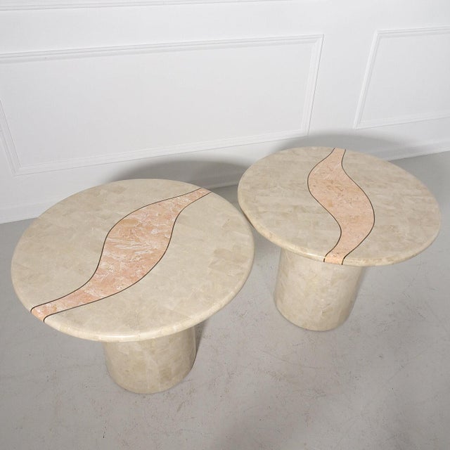 Stunning pair of round pedestal tessellated stone tables inlaid with a modern abstract design trimmed in brass reminiscent...