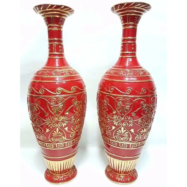 Pair of huge ceramic vases of Italian production from the 1960s, made of polychrome red and gold ceramic, with relief...