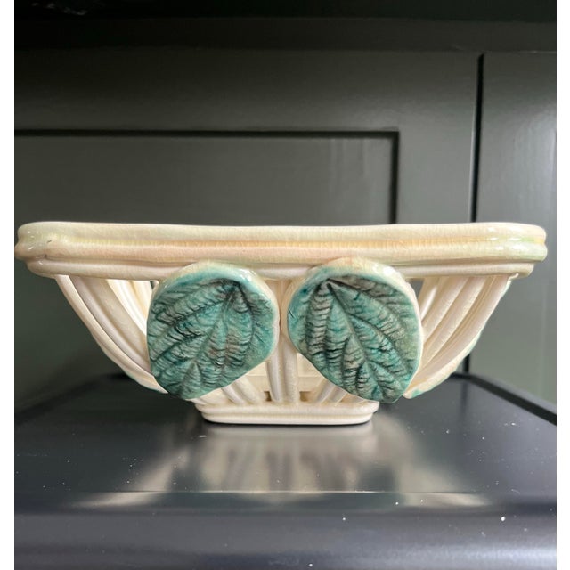 A beautiful French open weave bowl with rich green applied barbotine lemon leaves. Tres charmant!
