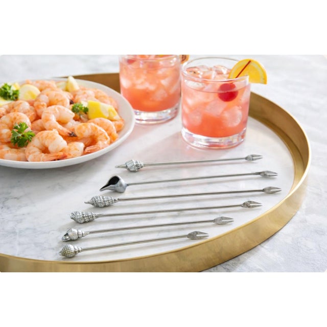 Elevate your bar cart or seafood spread with this set of 6 long pewter cocktail picks by Designs by Metzke, each topped...