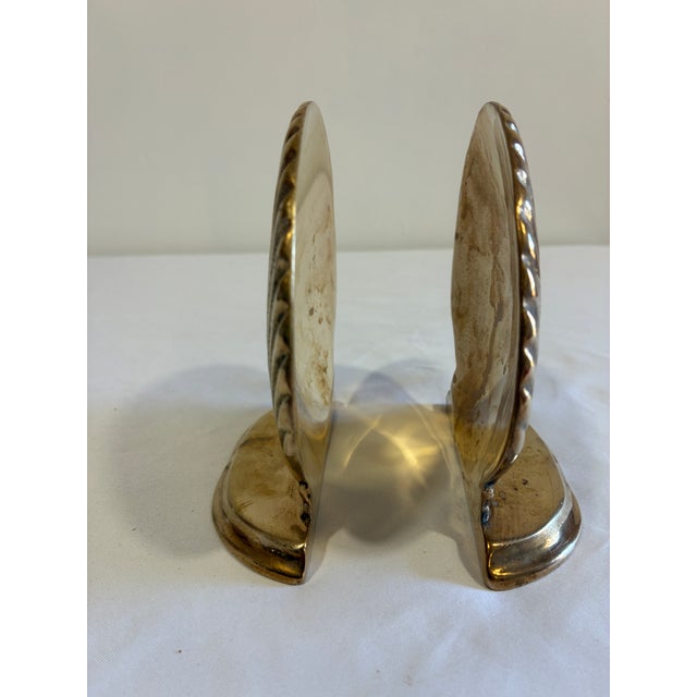 A charming pair of vintage brass bookends designed in the form of scallop seashells. Each shell features pronounced ribbed...
