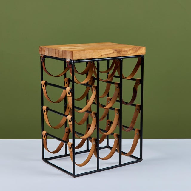 Arthur Umanoff wine rack, c.1950s, USA. The rack features a wrought iron frame with leather strapping to store up to...