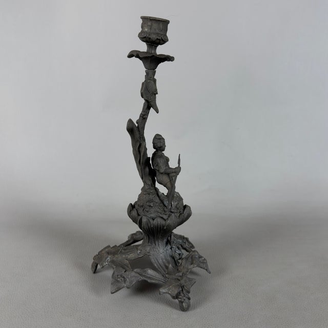 A charming and dramatic sculptural metal candlestick, attributed to decorative workmanship from the early 20th century....