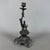A charming and dramatic sculptural metal candlestick, attributed to decorative workmanship from the early 20th century....