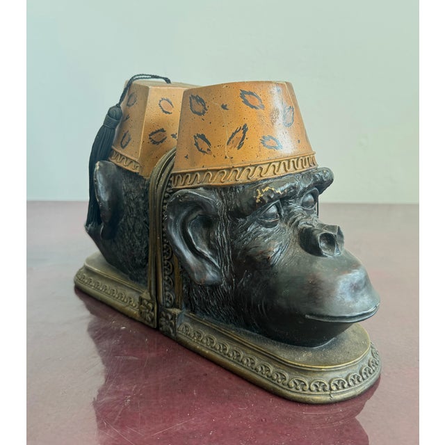 Unconventional and humorous, these sculptural bookends feature detailed monkey heads wearing fez hats that double as...