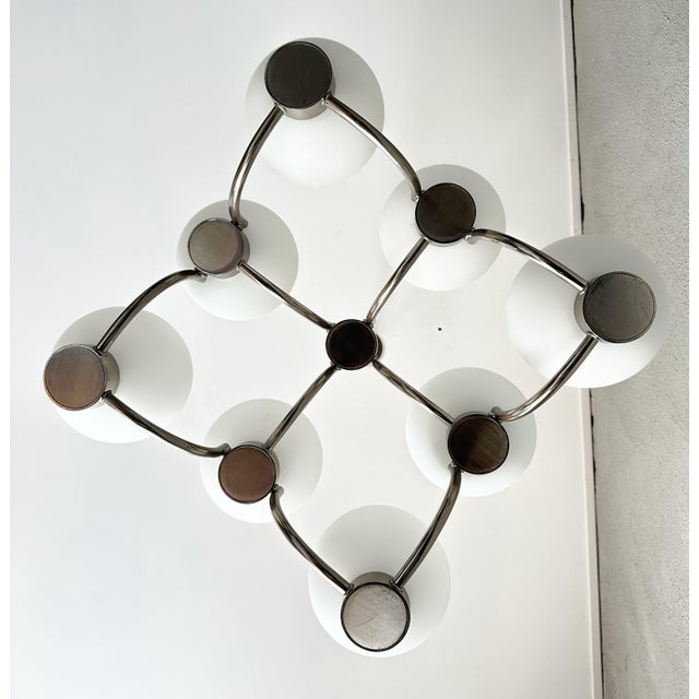Iconic Boulanger Sputnik lamp with 9 white spheres, mounted on a brushed stainless steel frame. A distinctive design piece...