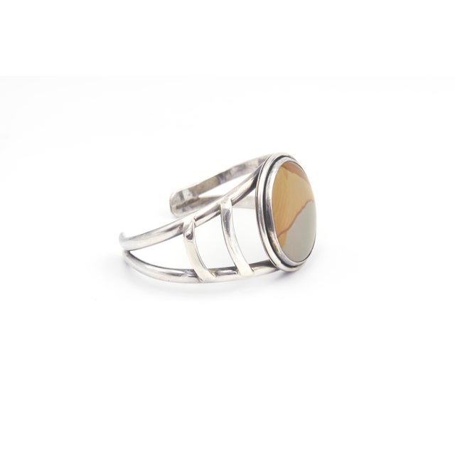 Sterling Silver Cuff Bracelet with Banded Jasper A sterling silver cuff bracelet featuring a round, bezel-set banded...
