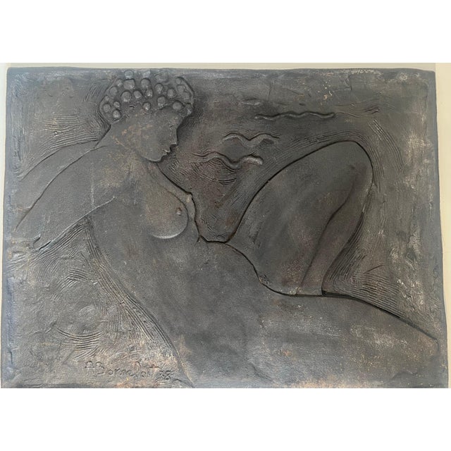 This very beautiful and interesting fireback is made of cast iron. It depicts a nude woman in the style of Paul Gauguin....
