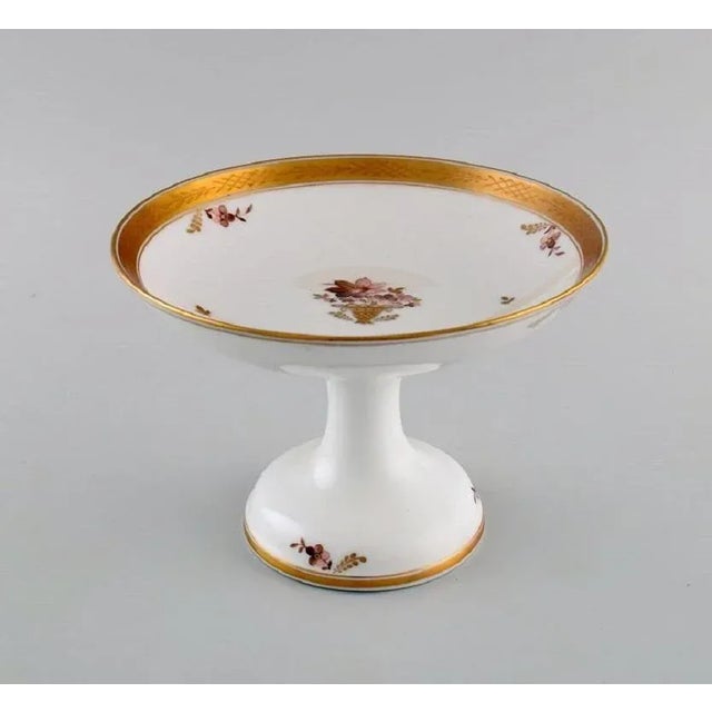 Royal Copenhagen Golden basket compote in porcelain with flowers and gold decoration. Model number 595/9410. Early 20th...