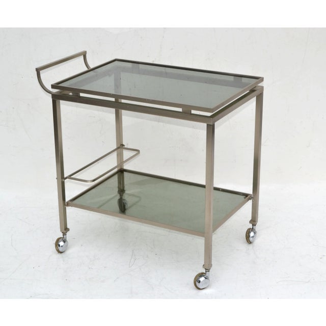 1 of 2 French Bar Cart two-tier by Guy Lefevre for Maison Jansen. 1960 in Chrome with smoked Glass Shelves and all...