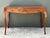 This vintage Italian writing desk showcases rich burl wood with swirling, honey-toned grain across its desktop, paired...