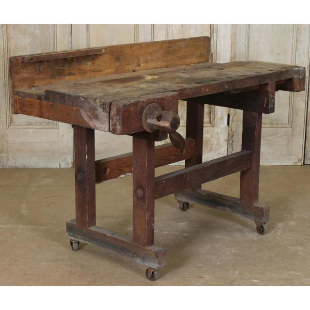 Stunning antique carpenter's workbench, a sculptural piece with soul. This authentic carpenter’s workbench bears the...