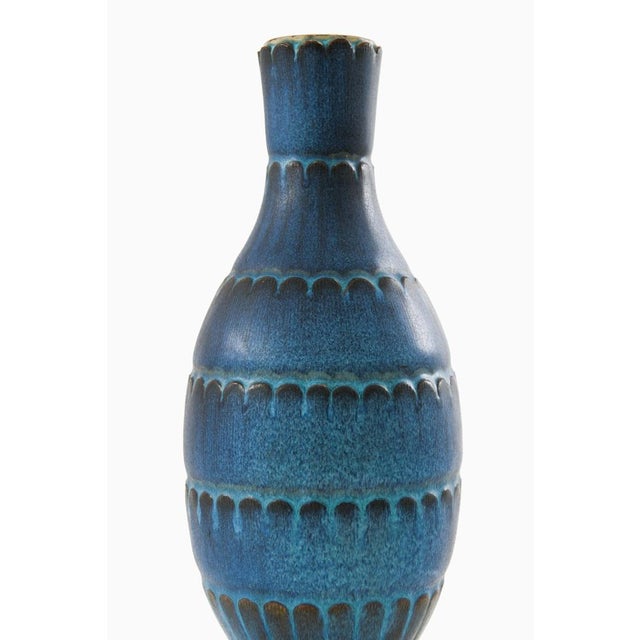 This rare ceramic vase, model farsta, was designed by wilhelm kåge and produced by gustavsberg in sweden as part of the...