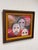 Design Plus Gallery presents a Framed Acrylic Painting. The painting depicts three expressive mask forms set against...