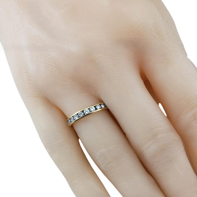 14 Karat Yellow Gold and Diamond Eternity Band Ring Size- This timeless 14K yellow gold eternity band features 24 round...