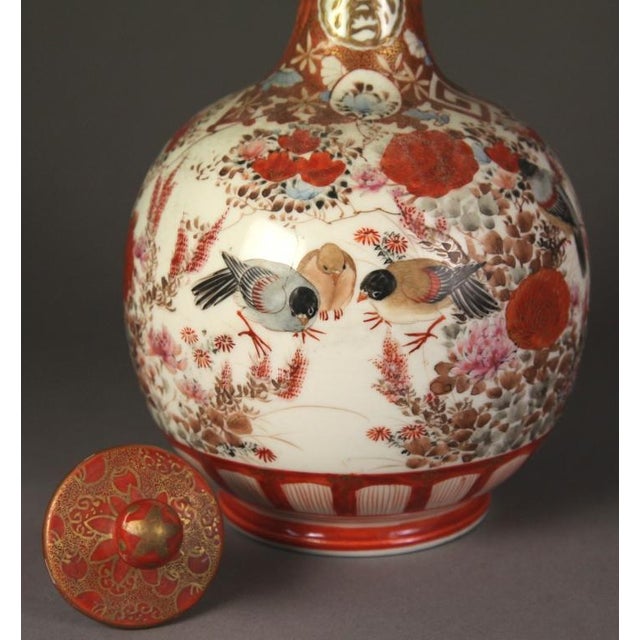 A hand-painted antique Japanese Kutani porcelain bottle vase with its original stopper, made in the late Meiji period,...