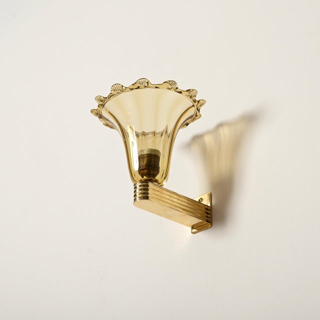 Marvelous pair of art deco sconces in mouth-blown murano glass and brass. These incredibly elegant sconces were produced...