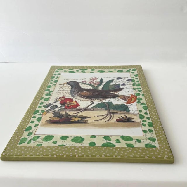 Quintessential John Derian bird surrounded by green dotted decoration. This ceramic tile for Tozai home weighs 5 lbs and...