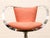 glamorous 1970s swivel armchair with a sculptural chrome halo frame and soft blush velvet upholstery. The continuous...