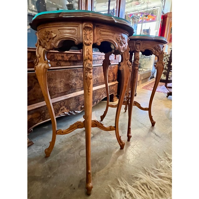 Beautifully carved set of round walnut tables with glass tops. 18.5"w x 29.5"h