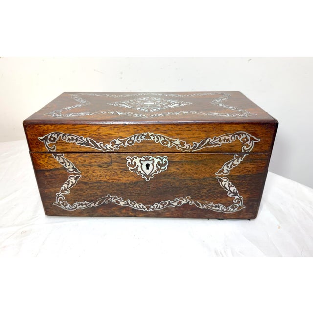 Up for sale is an exquisite antique English mother of pearl inlaid rosewood dual tea caddy box from the second half of the...