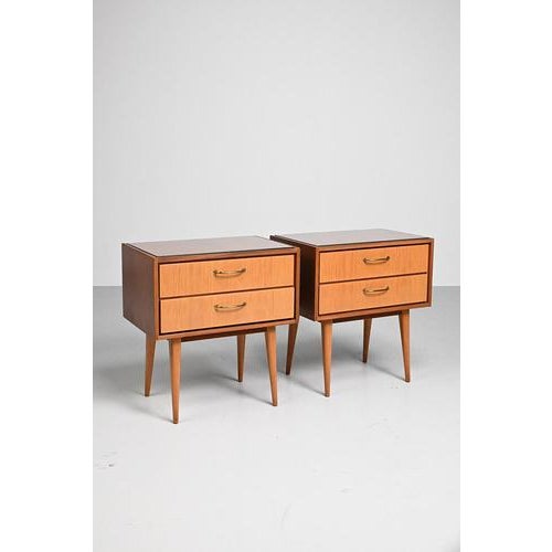 Set of 2 night stands from the 60’s, made in Germany. with its sloping legs, gold colored metal handles and glass on top...